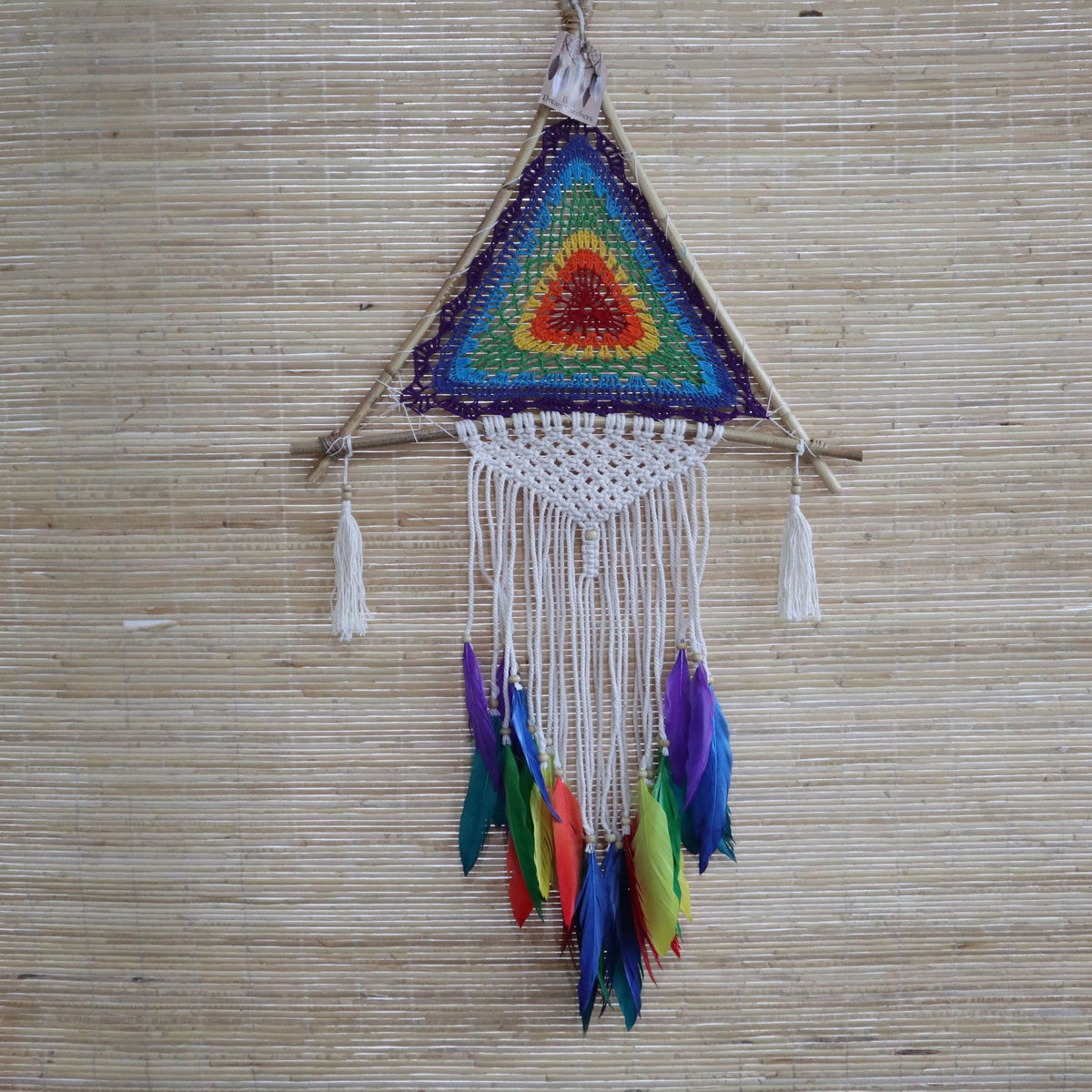 Large Multi Pyramid dreamcatcher hanging against a pale woven wall, showing its full shape