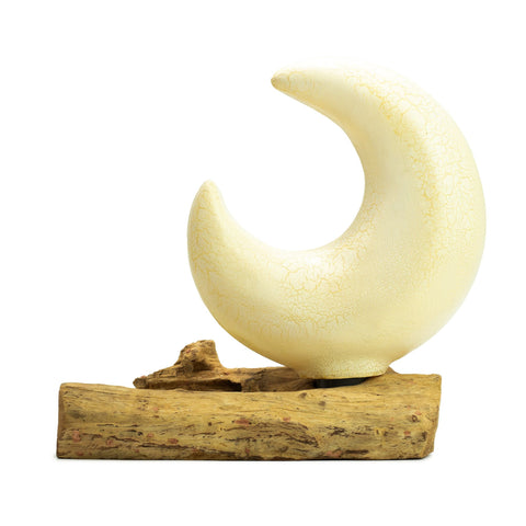 Crackle half moon shade shown from the front on its rectangular driftwood base against white