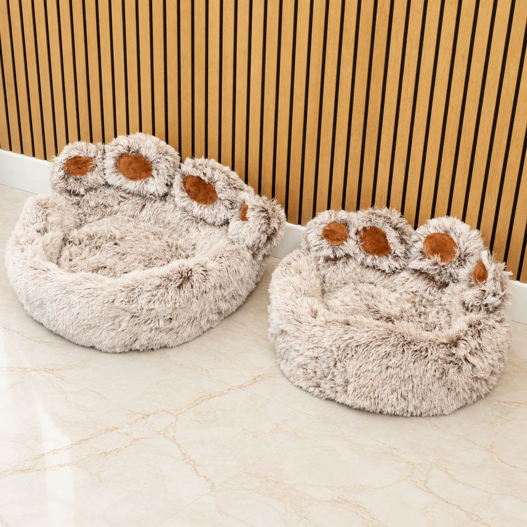 Two shaggy paw-shaped pet beds shown side by side