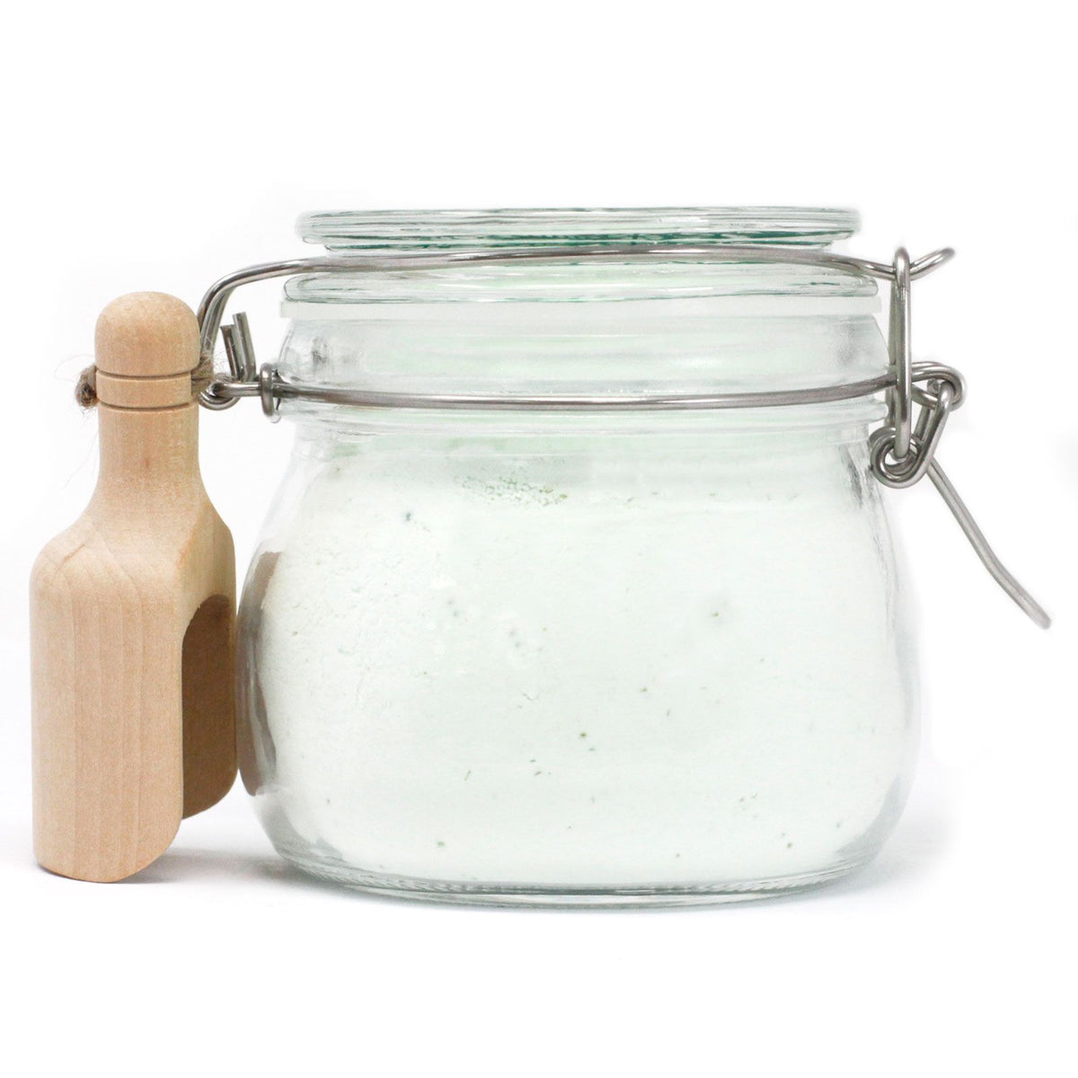 White Fig Fairy Dust in a clear clasp jar with a wooden scoop attached at the side