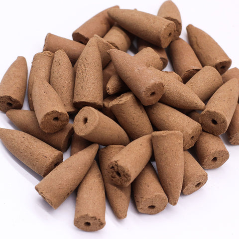 Pack of 10 Masala Backflow Incense, Sage, brown cones scattered in a close-up on a white background