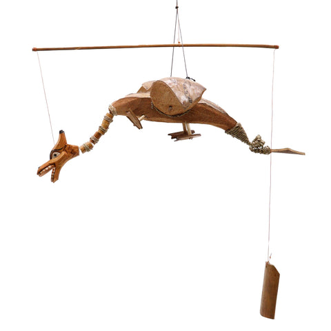 Natural coconut-shell dragon mobile hanging from its wooden stick, full view