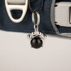 Close-up of the black paw charm on the harness