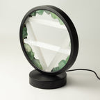 Angled view of the lamp's circular frame and base
