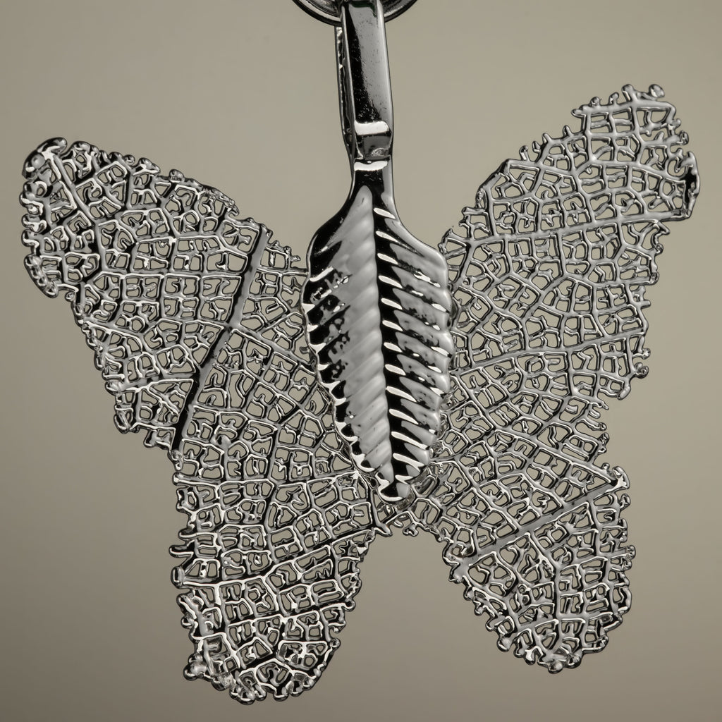 Close-up of the silver-coloured butterfly charm
