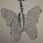 Close-up of the silver-coloured butterfly charm