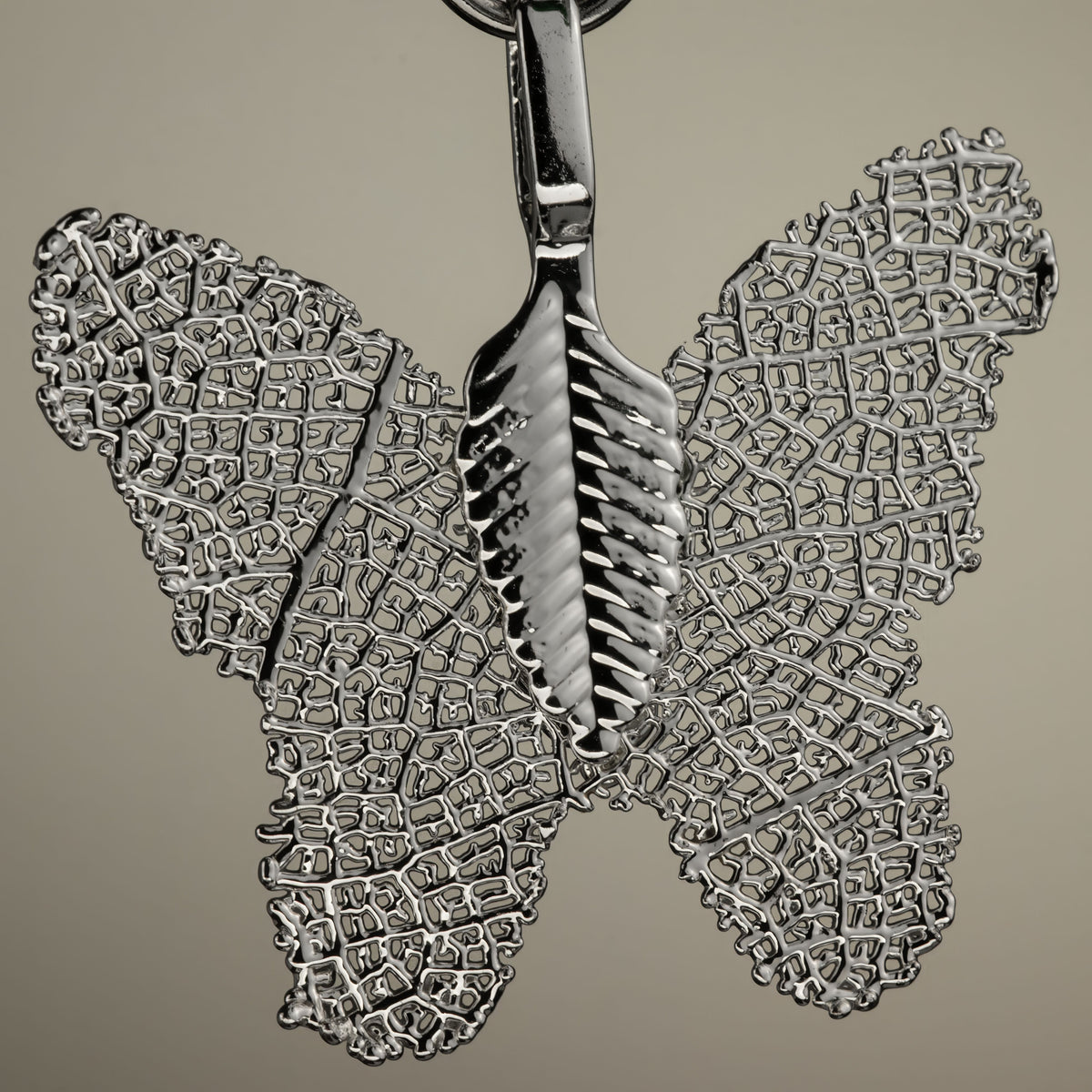 Close-up of the silver-coloured butterfly charm