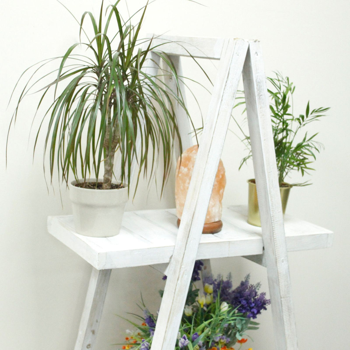 Folding Wooden A-Frame Shelf in whitewash, close view with potted plants and flowers on its shelves