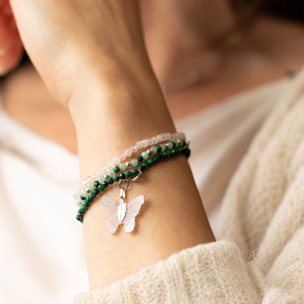 Three bracelets worn together on a wrist