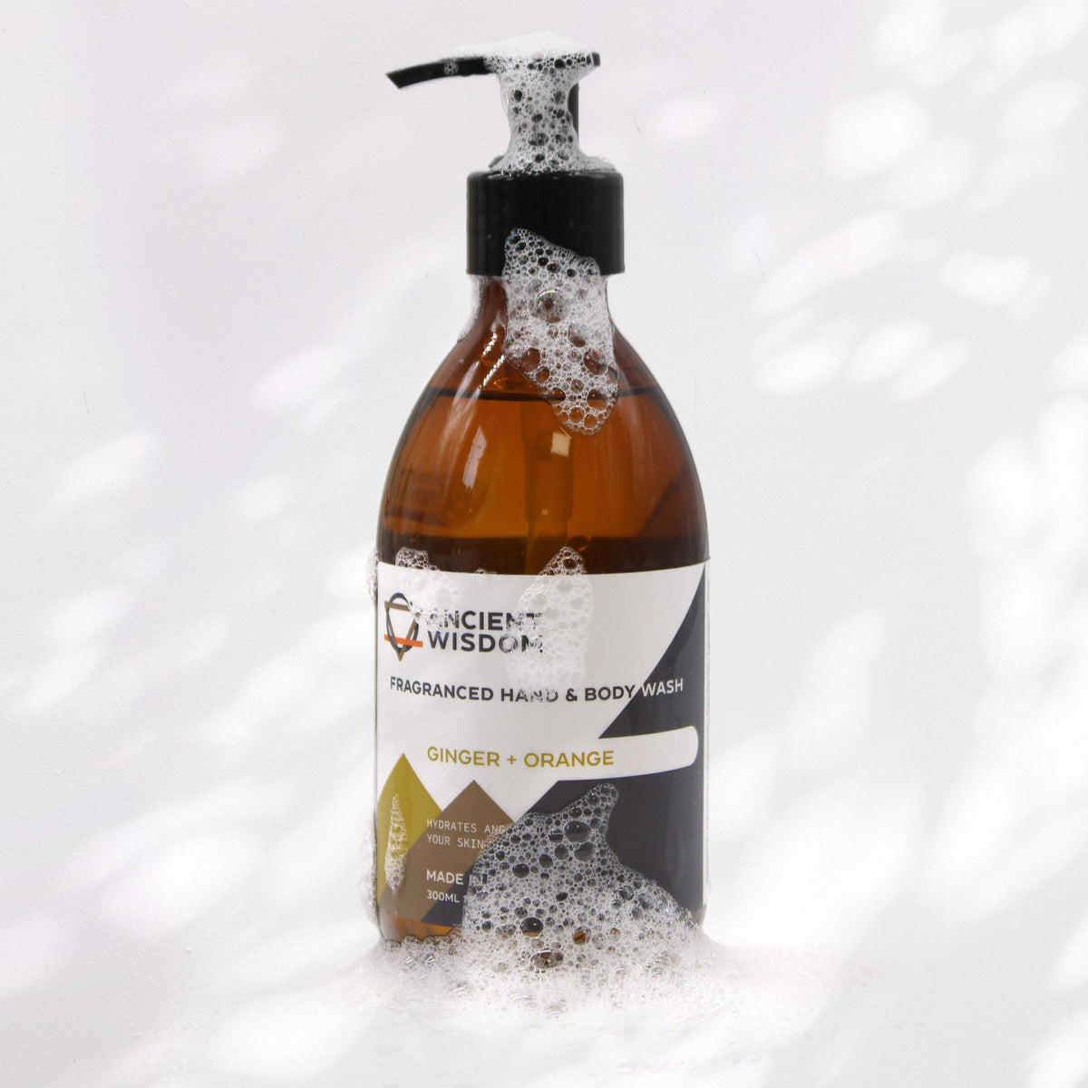Ginger + Orange hand and body wash bottle with foam, from the same range