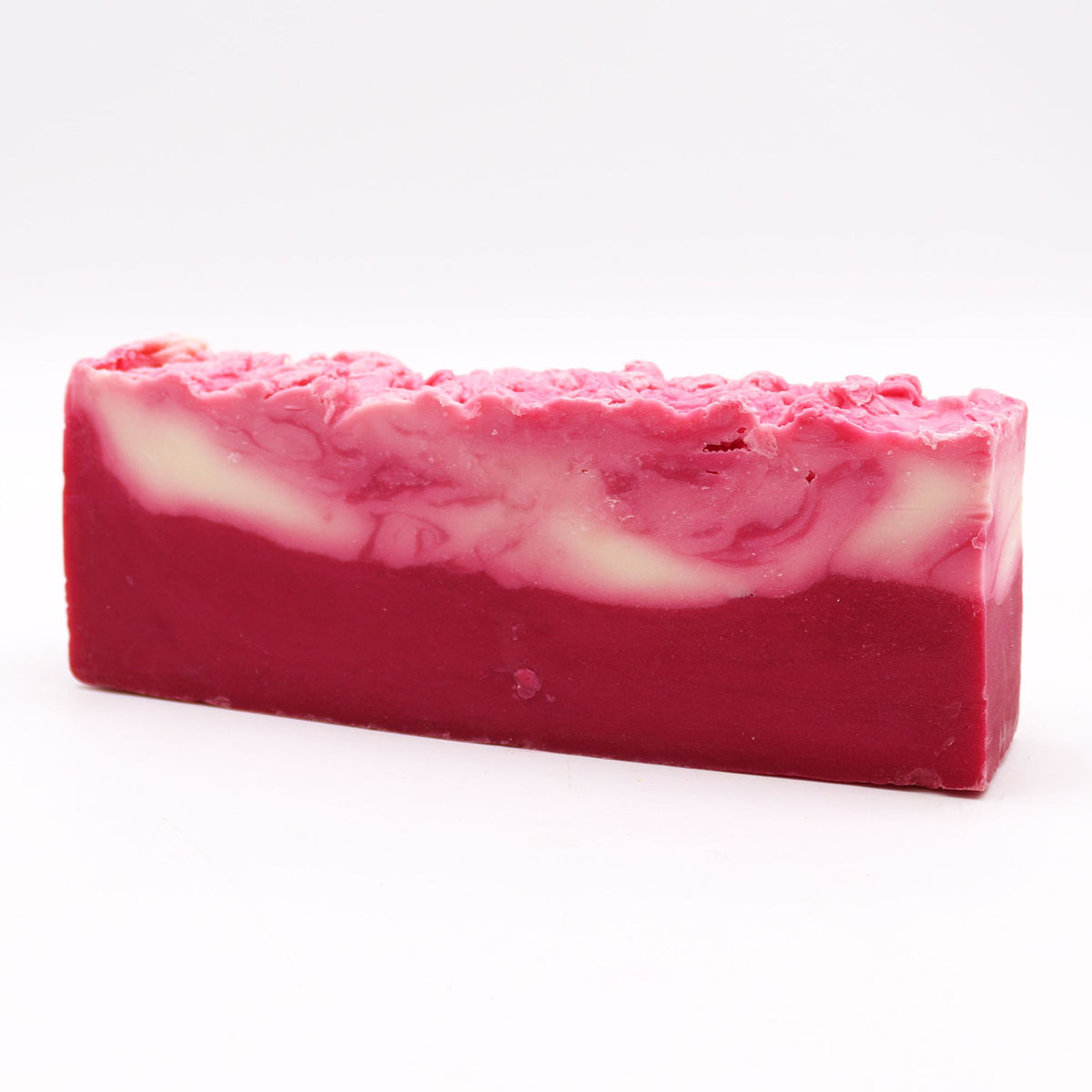 Shea Butter, Olive Oil Soap Loaf, a long pink and cream marbled bar on a white background