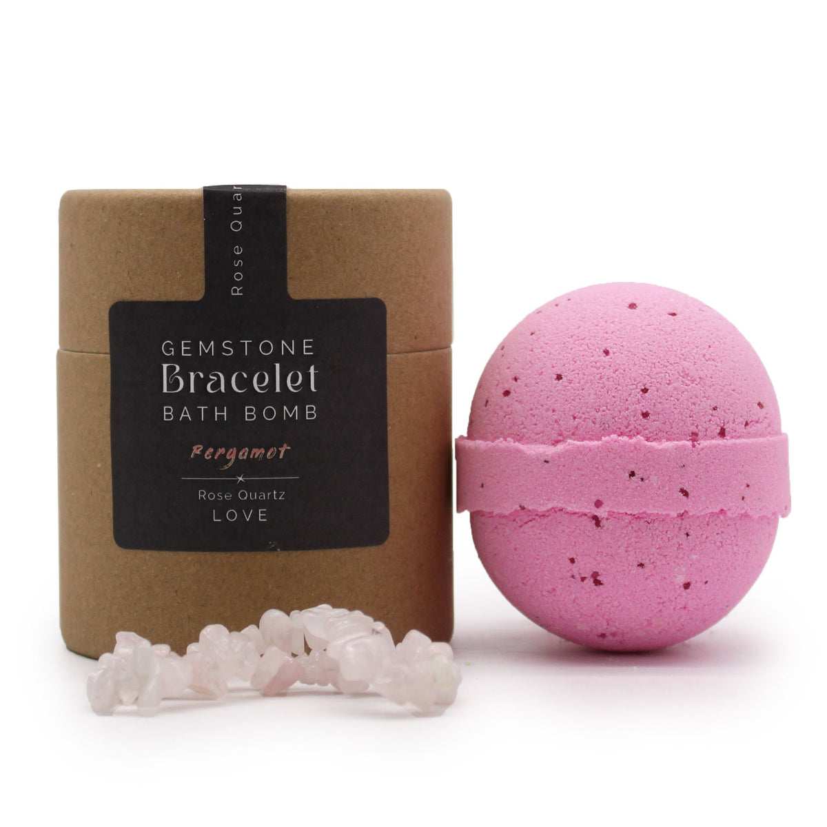 Pink bath bomb and pale stone bracelet beside a brown tube with its front label facing forward