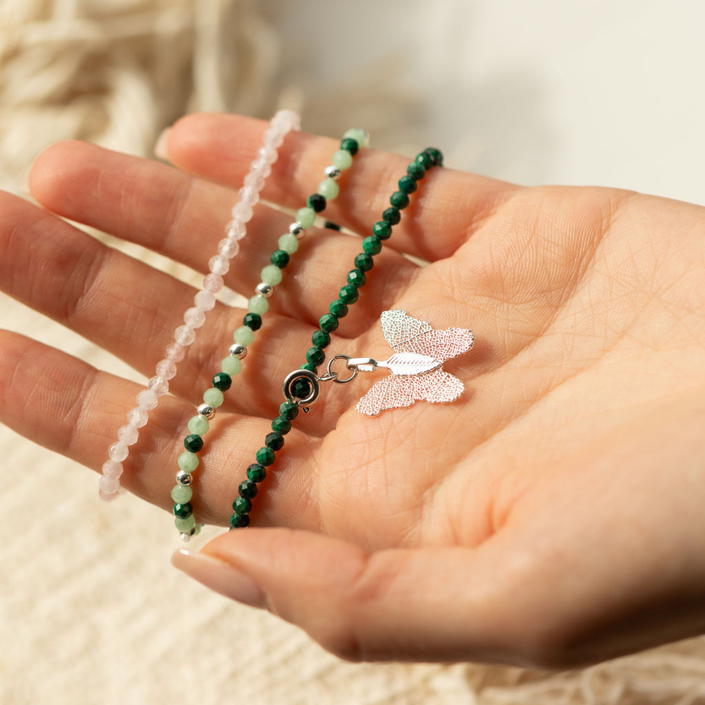 Three bracelets shown across an open palm