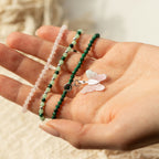 Three bracelets shown across an open palm