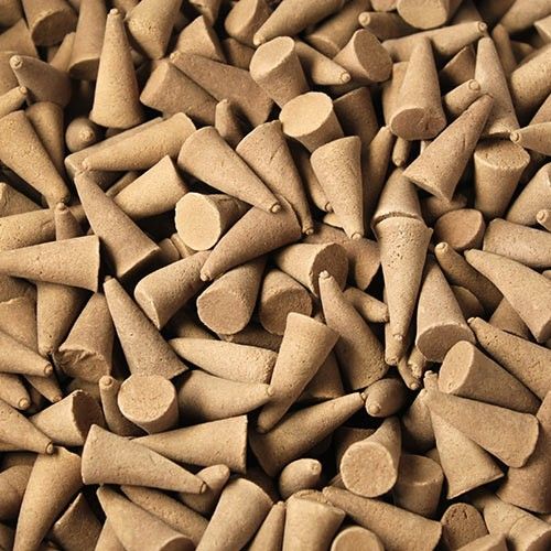 Bulk Incense Cones, Amber, a close-up view of many tan cones piled together