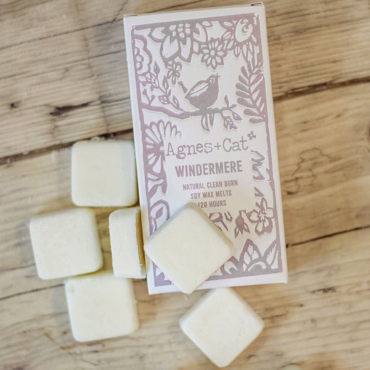 Agnes + Cat Box of 8 Wax Melts, Windemere, box and pale square melts on a wooden surface