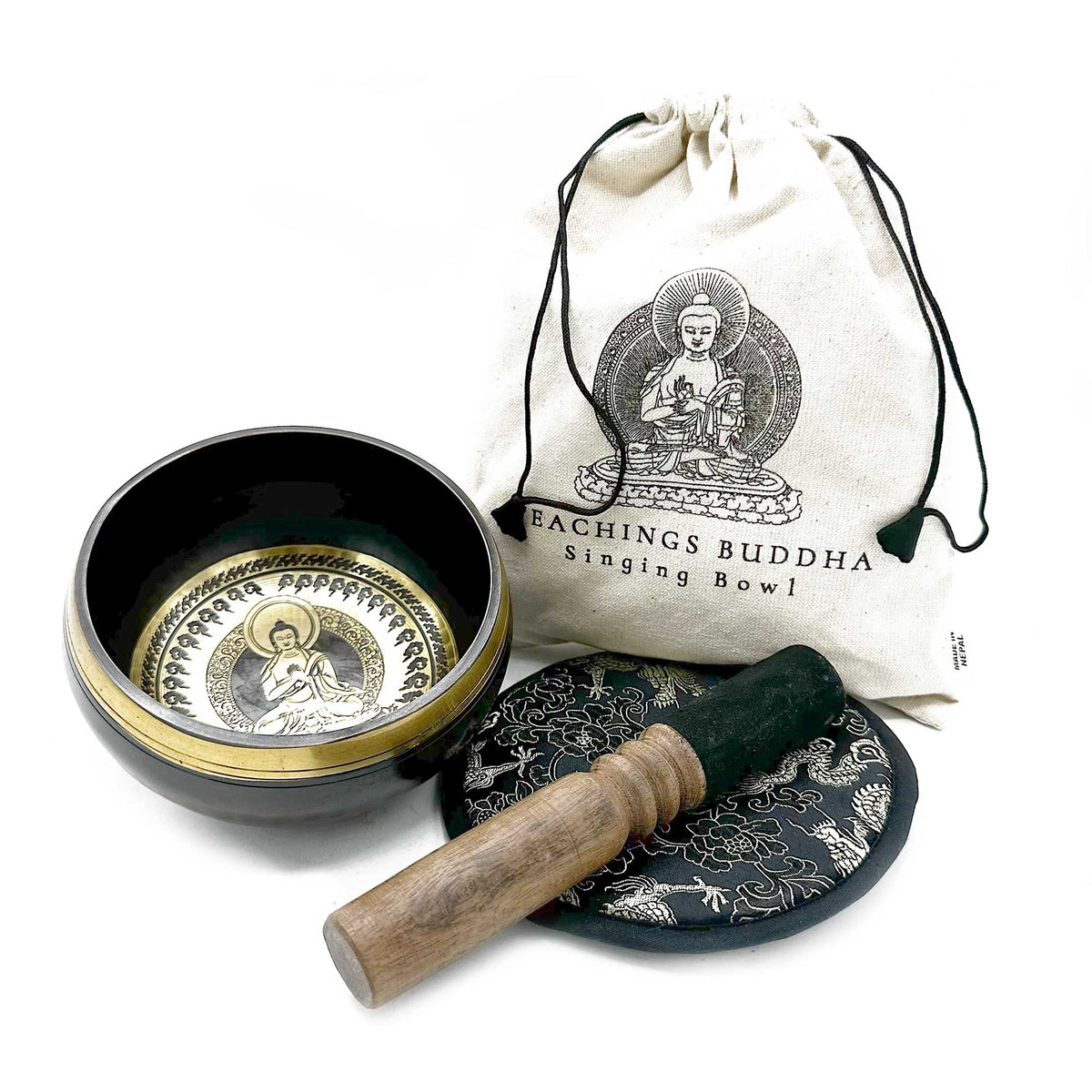Teachings Buddha singing bowl set with engraved bowl, wooden striker, patterned cushion and drawstring pouch on white
