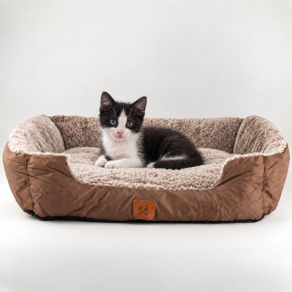 PAW Teddy Brown plush pet bed with a kitten resting inside