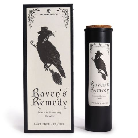 Black candle with cork lid beside its upright box, shown against a white background