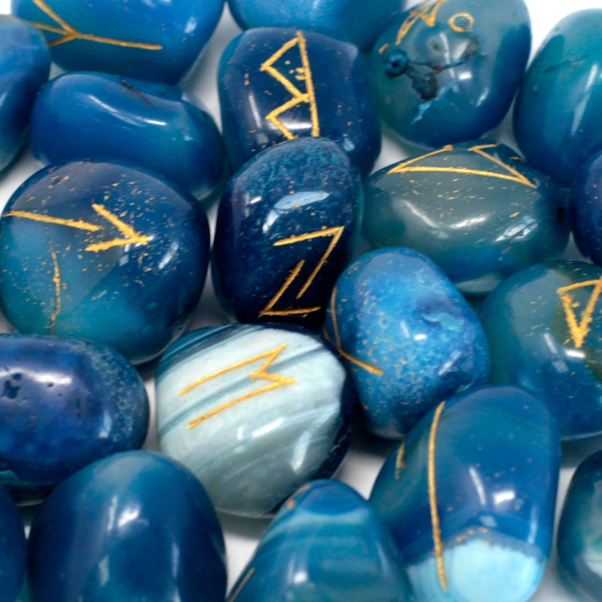 Runes Stone Set in Pouch, Blue Onyx, close-up of polished blue stones with gold rune markings