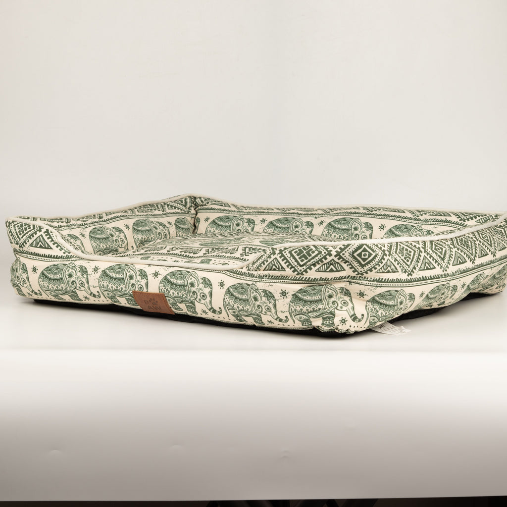 Side view of the green elephant-patterned pet bed