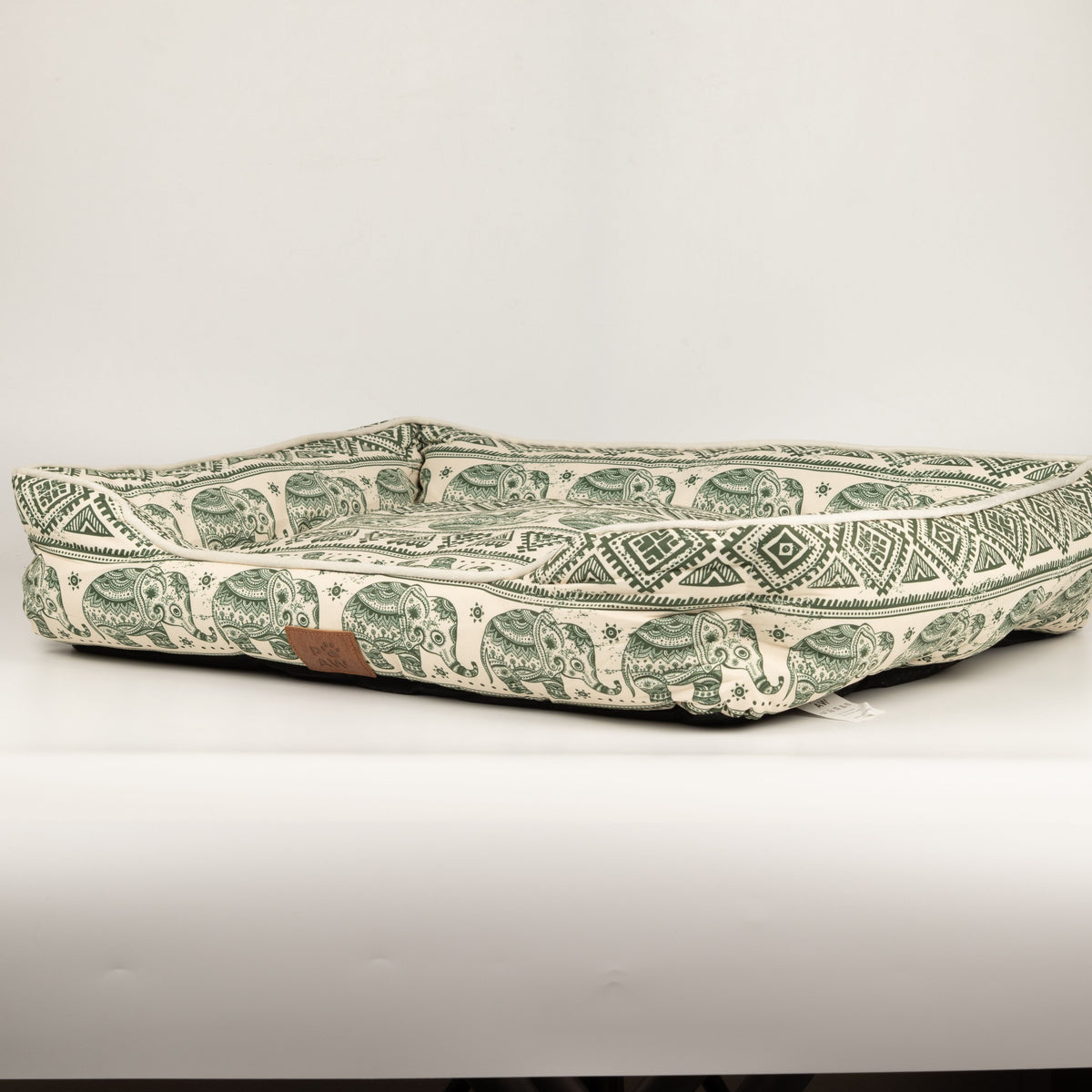 Side view of the green elephant-patterned pet bed