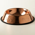 Copper-style pet bowl with embossed paw prints and black edge