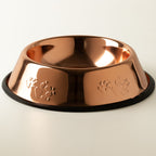 Copper-style pet bowl with embossed paw prints and black edge