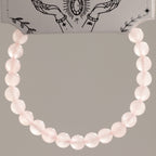 Close view of the rose quartz bracelet hanging in a loop