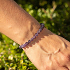 Close view of the purple amethyst beads worn on a wrist
