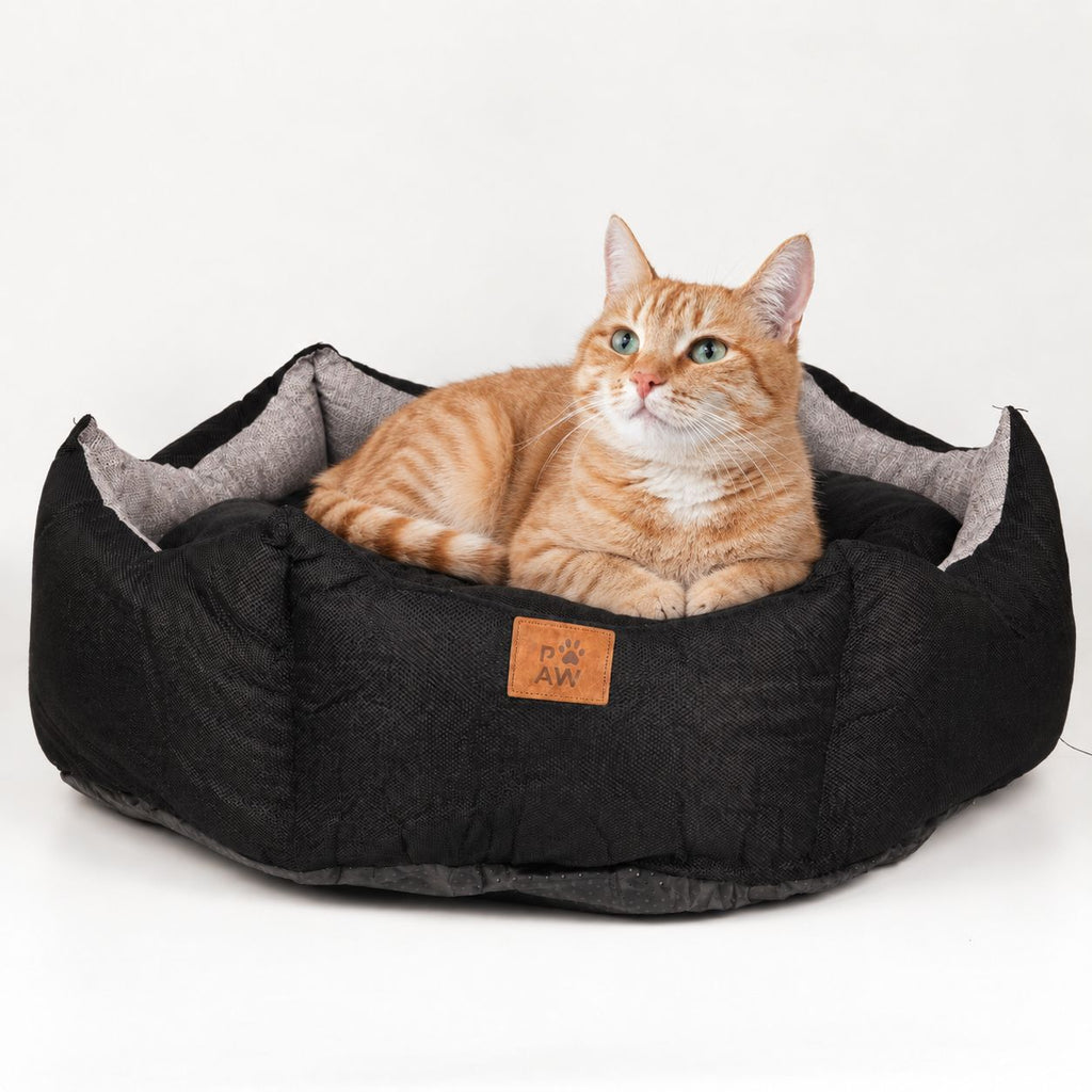 Black and grey pet bed shown with a cat