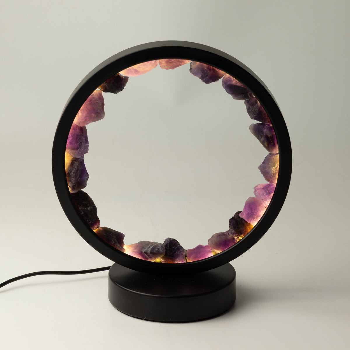 Zen Spirit amethyst halo lamp lit, showing the circular ring of purple stones