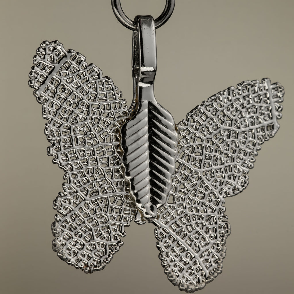 Close-up of the silver-coloured butterfly charm