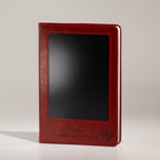 Red notebook standing upright with its front screen visible
