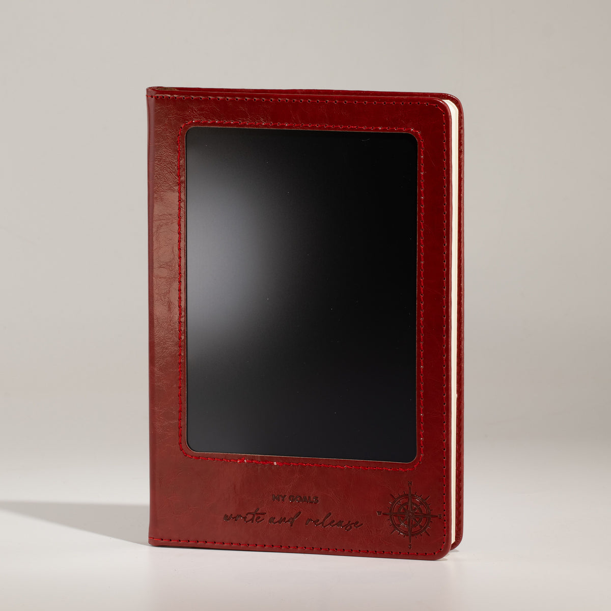 Red notebook standing upright with its front screen visible