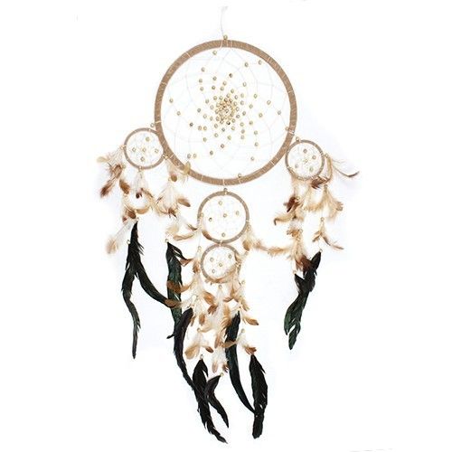 Cream and coffee Bali dreamcatcher hanging against white, with bead-decorated web and dark feathers