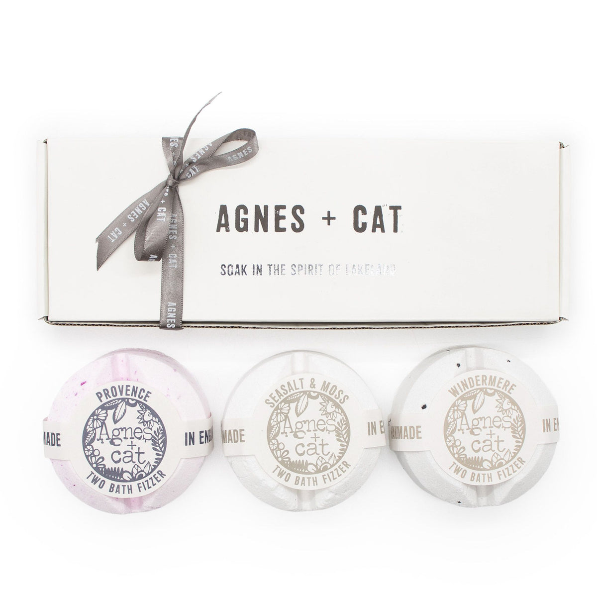 Gift set front view, a white ribbon-tied Agnes + Cat box above three labelled bath fizzers