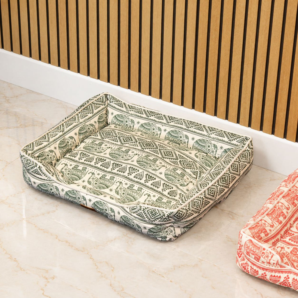 Green elephant-patterned bed viewed from above