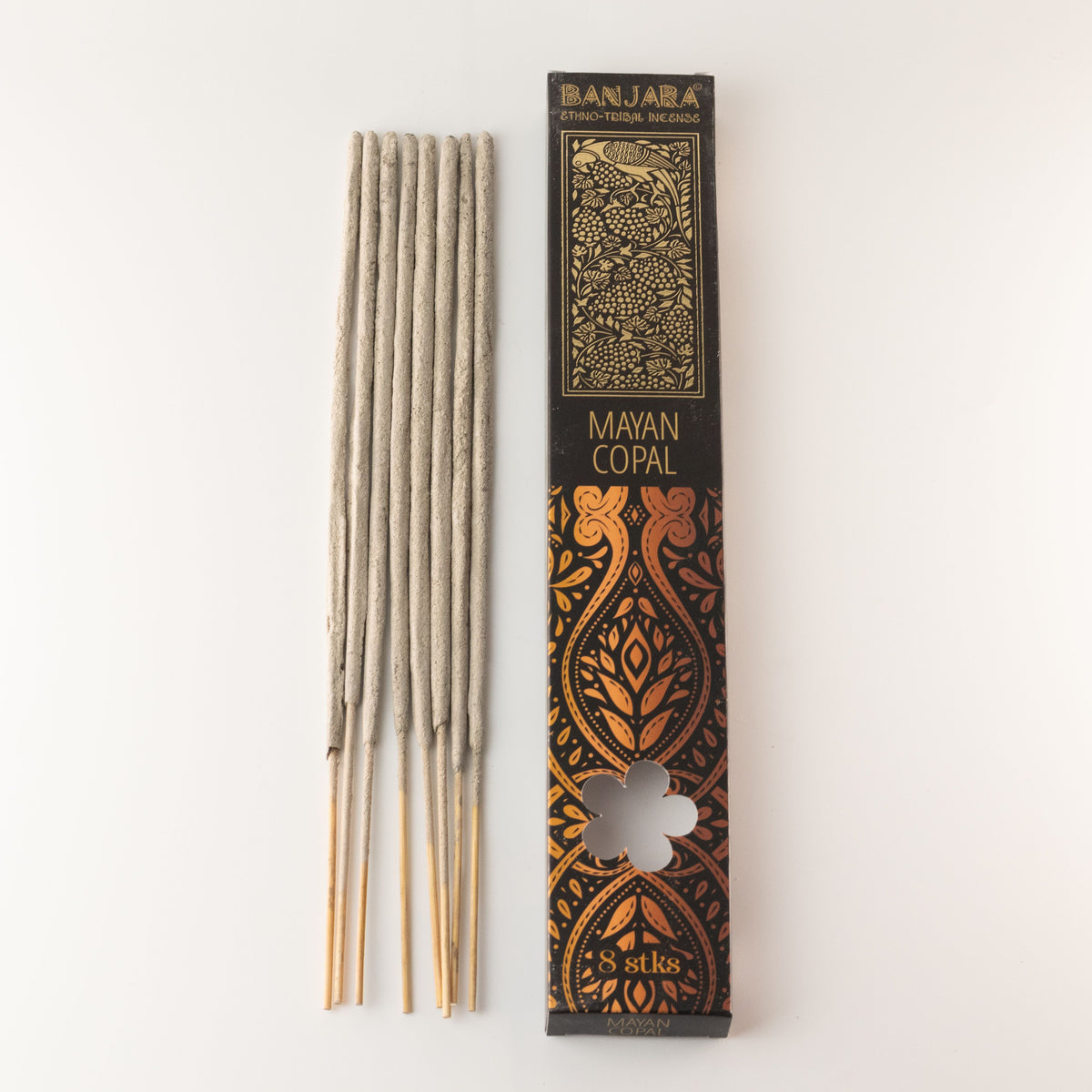 Mayan Copal stick pack beside several pale incense sticks, shown upright against a plain background