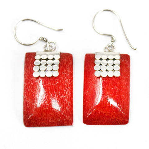 Close-up of the pair of red rectangular SQ Mini Disc earrings against a plain white background