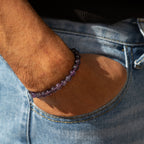 Amethyst bracelet worn on a wrist with denim