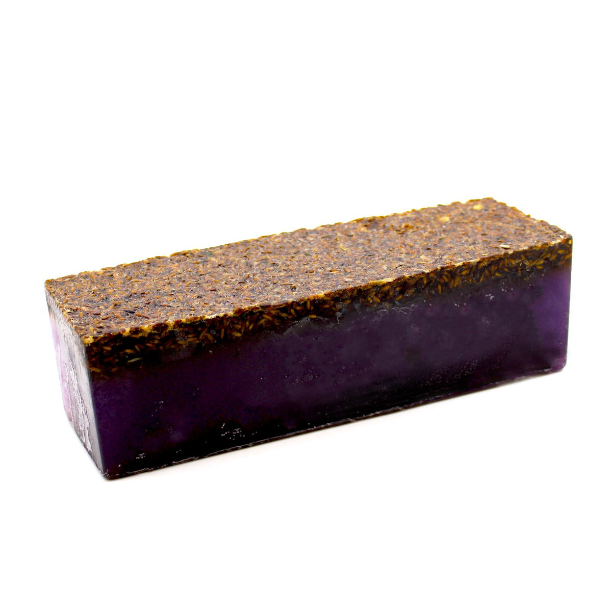 Lavender soap loaf with dried flowers layered across the top
