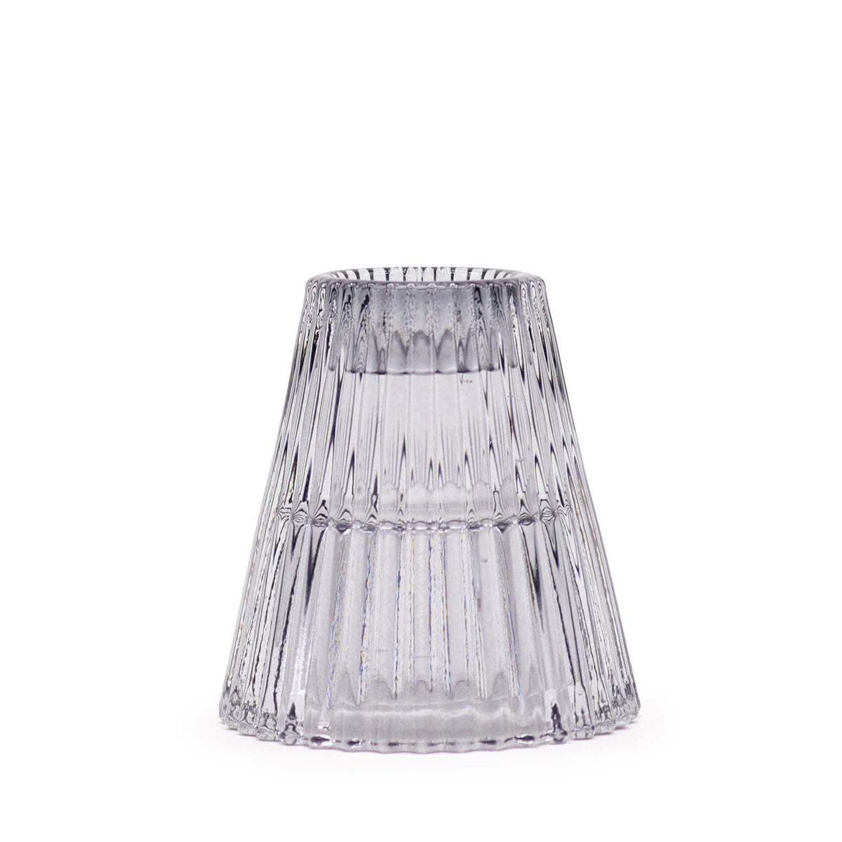 Ribbed glass candle holder shown upside down, revealing its flared shape and open base