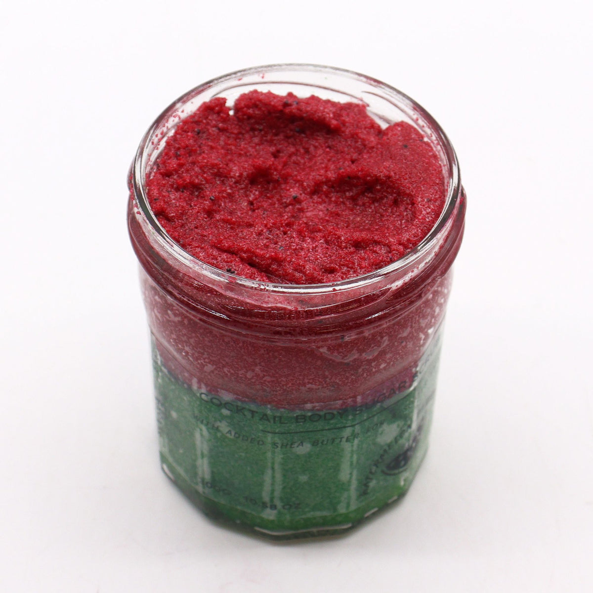 Fragranced Sugar Body Scrub, Watermelon Daquiri in a glass jar, open top showing red scrub above green
