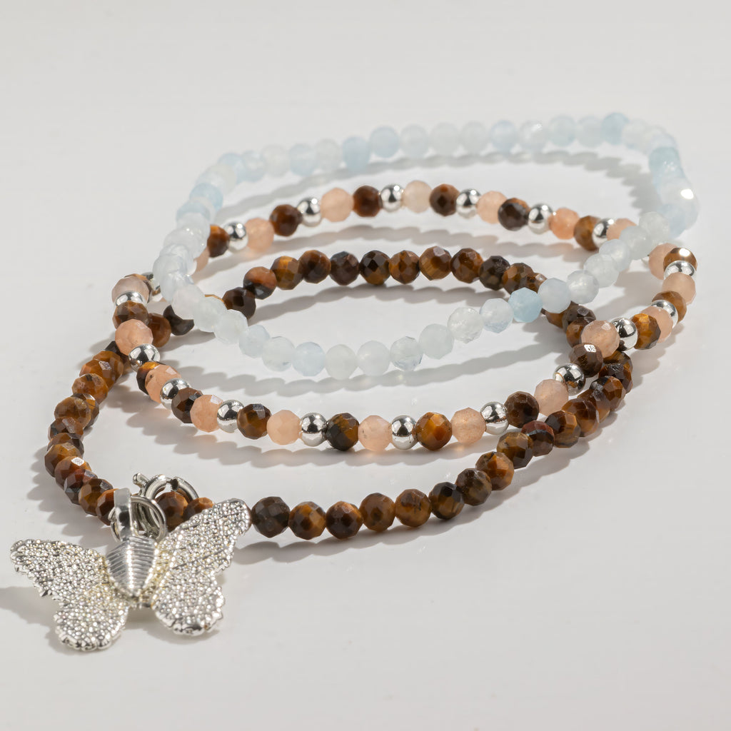Three beaded bracelets arranged in a coil
