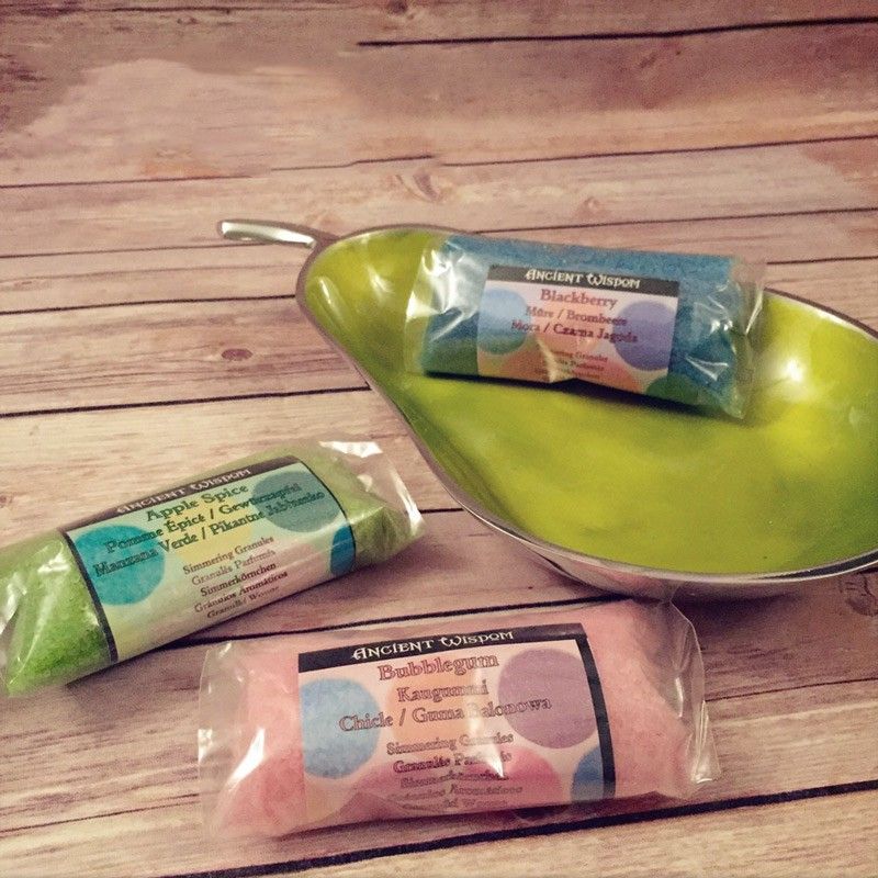 Blackberry Simmering Granules in a clear packet on a lime-green dish, beside other packets on wooden boards