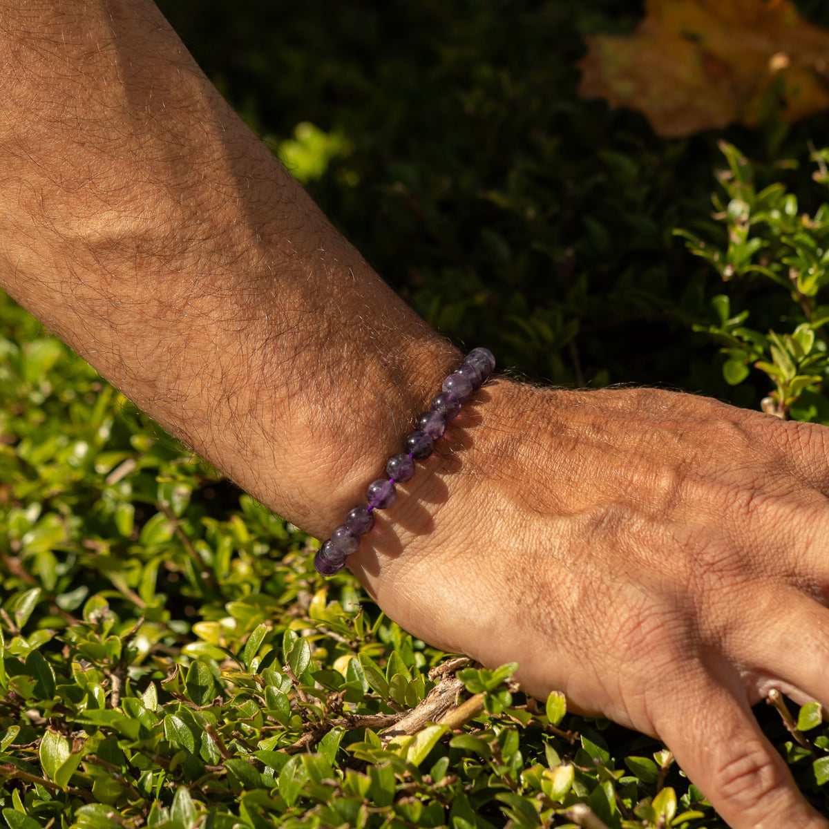 Amethyst bracelet shown on a wrist outdoors
