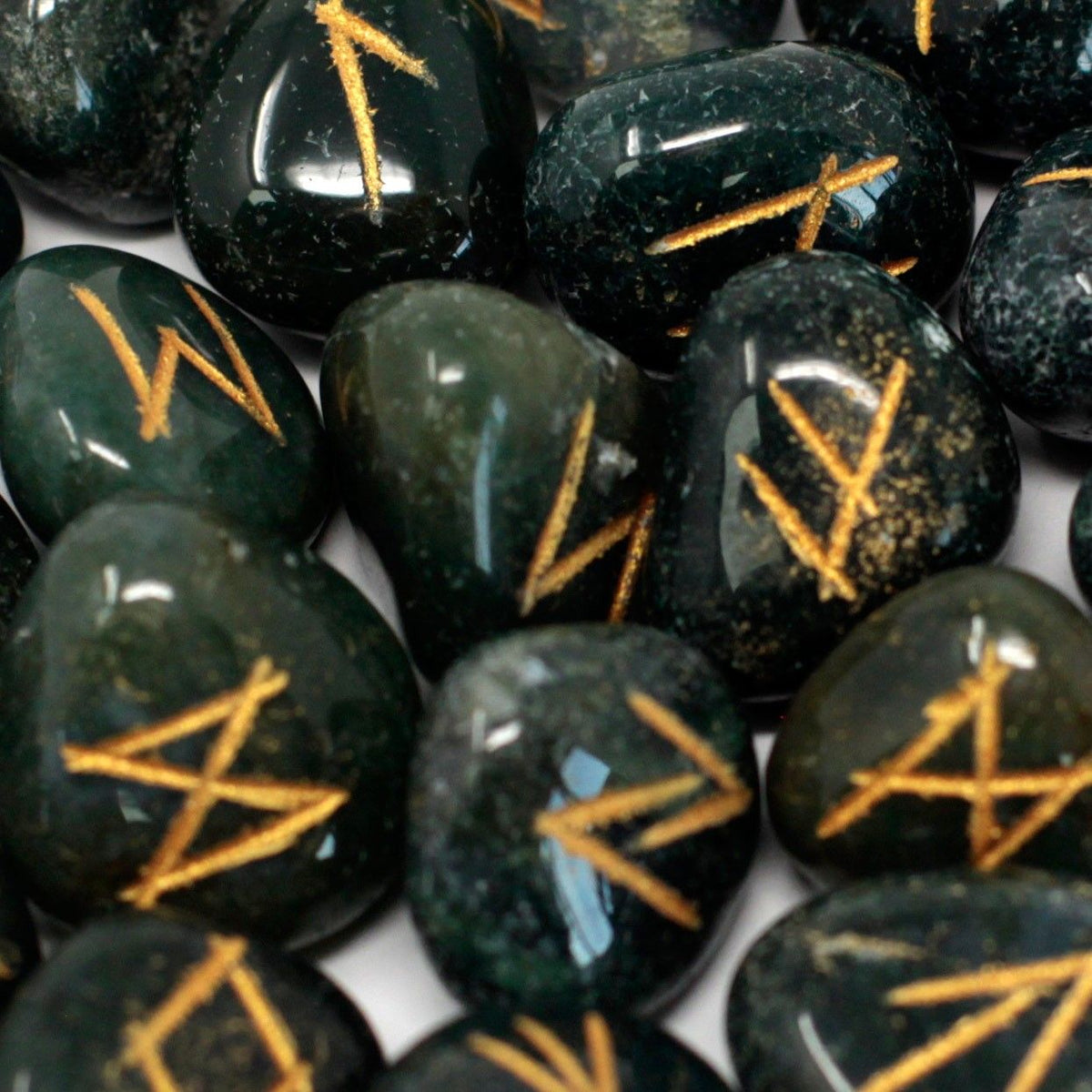 Runes Stone Set in Pouch, Bloodstone, close-up of polished dark green stones with gold rune markings