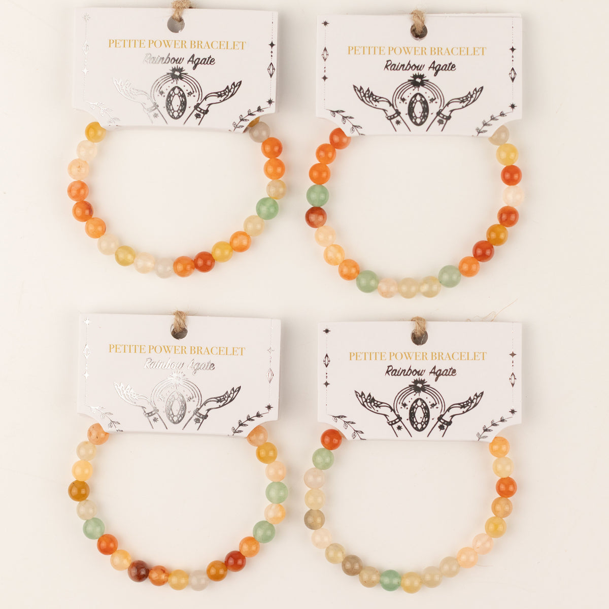 Four colourful beaded bracelets displayed on presentation cards