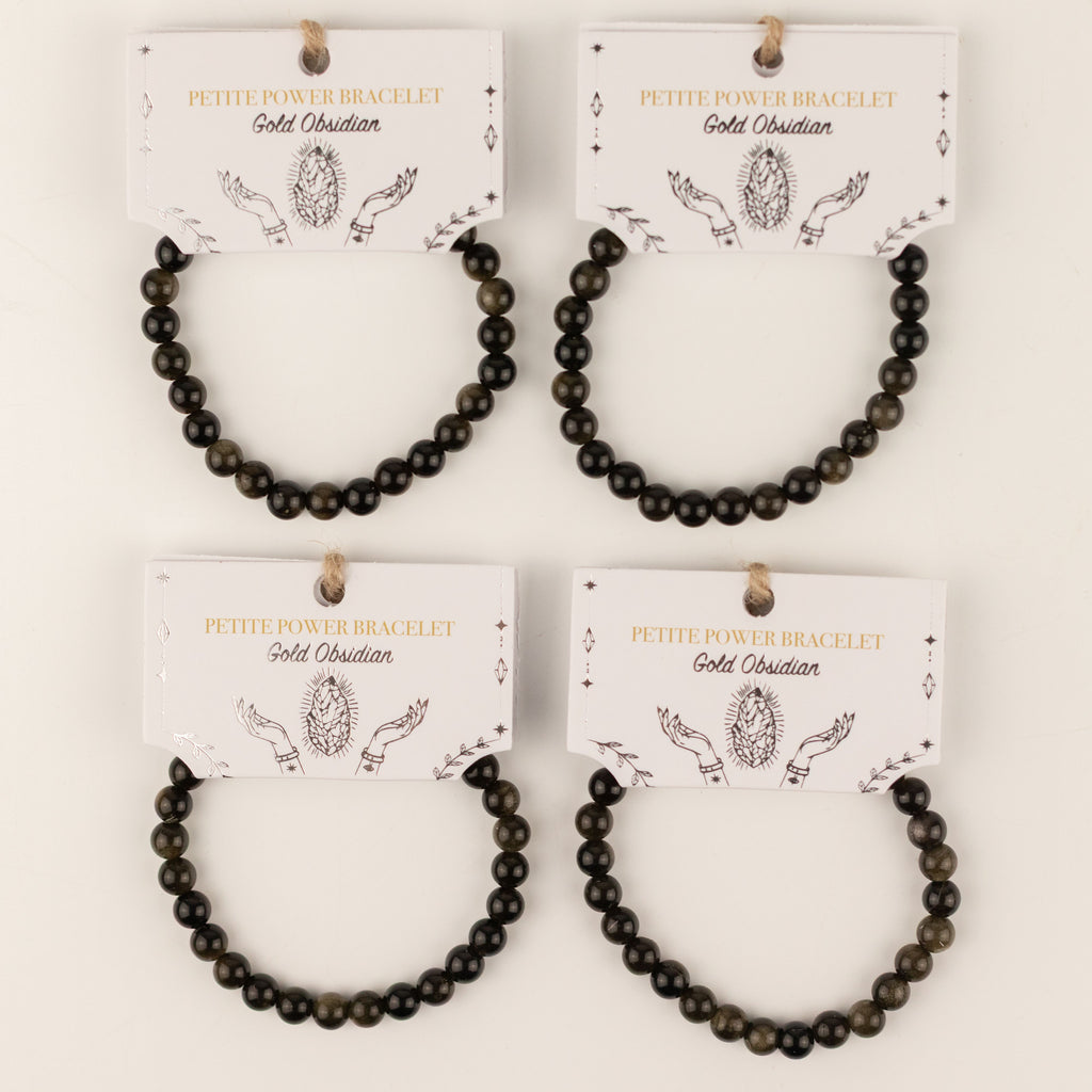 Four Gold Obsidian bracelets on illustrated presentation cards